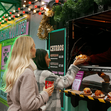 Friends ordering at a street food stall