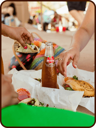 Friends sharing takeout boxes of street food and drinks
