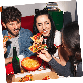 Friends sharing pizza and snacks together