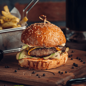 Juicy smash burger with cheese, pickles, and sesame bun